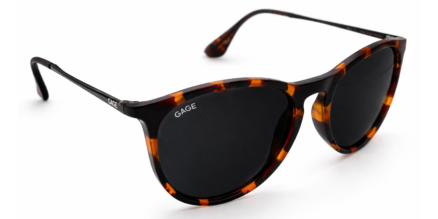 Sunglasses with tortoiseshell frame and black lenses on a white background