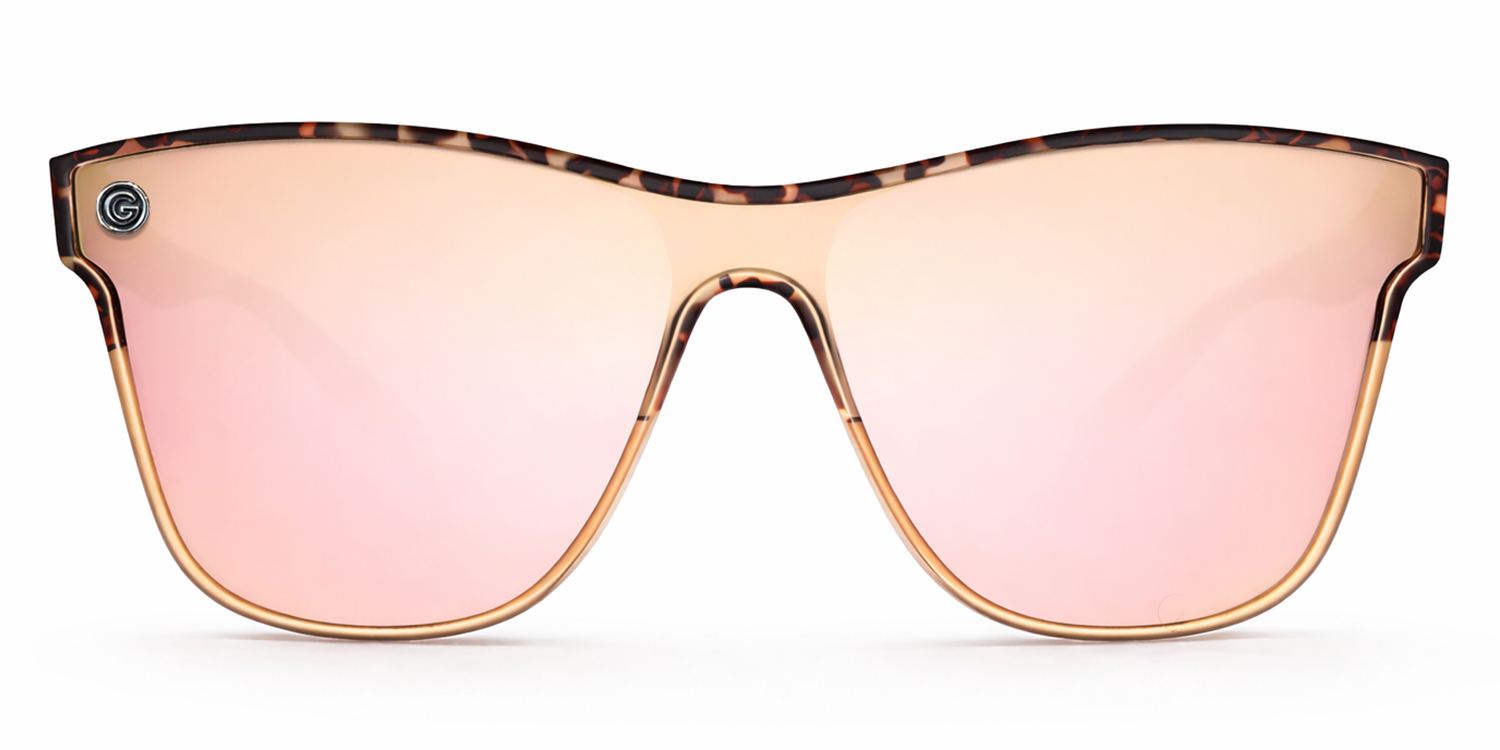 Sunglasses with a tortoiseshell frame and champagne lenses on a white background