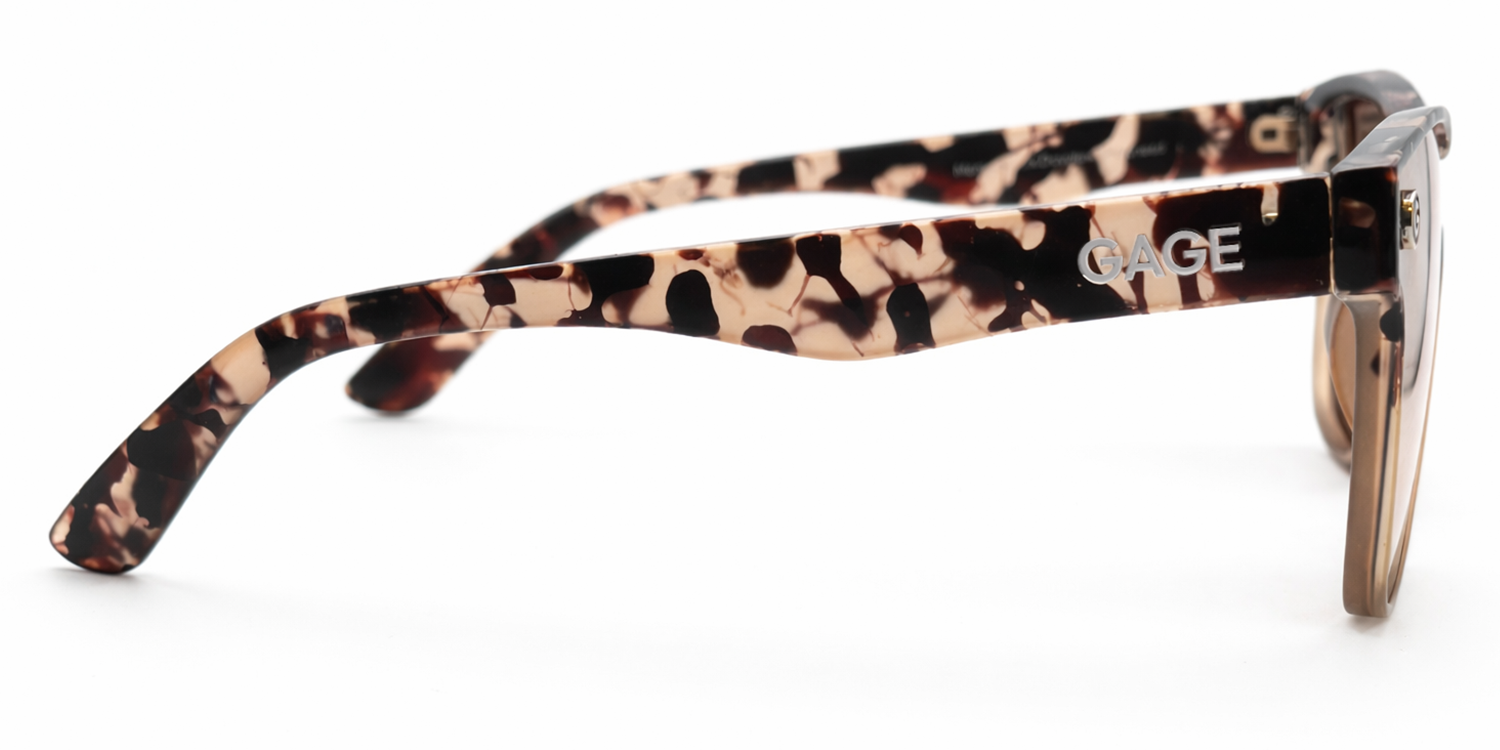 Sunglasses with a tortoiseshell frame and champagne lenses on a white background