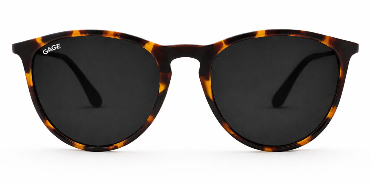 Sunglasses with tortoiseshell frame and dark lenses on a white background