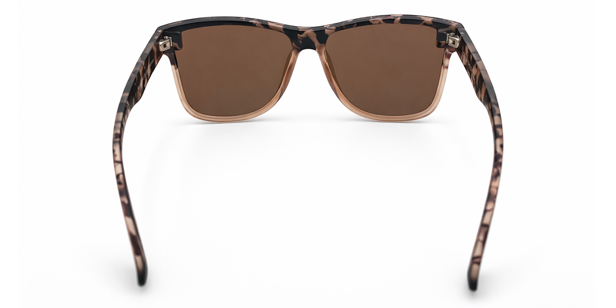 Sunglasses with a tortoiseshell frame and champagne lenses on a white background