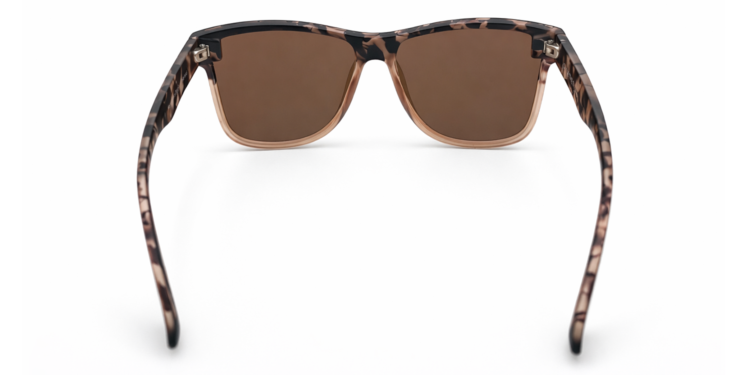 Sunglasses with a tortoiseshell frame and champagne lenses on a white background
