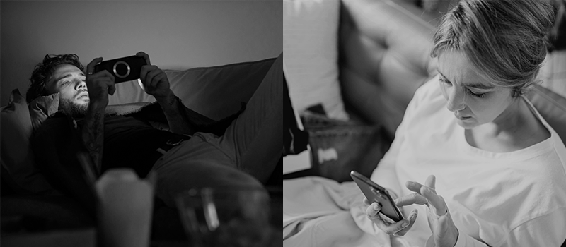 Man taking a photo with a camera, woman using a phone on a bed